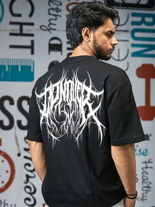 Man wearing black oversized gym t-shirt with bold white graphic back print, gym-themed background