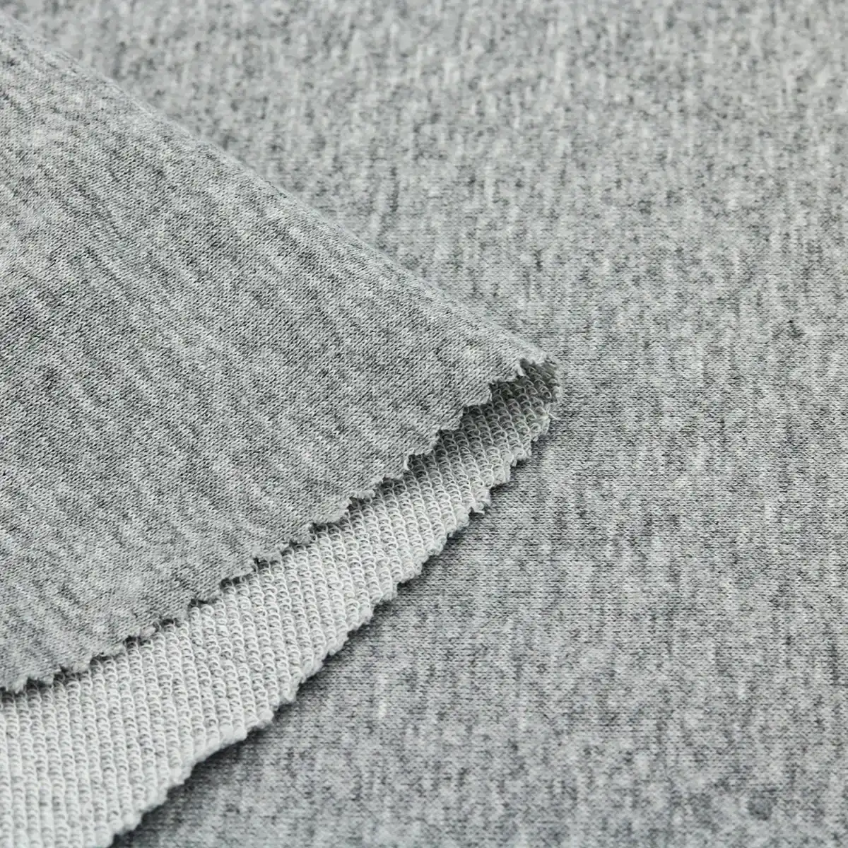 Close-up of heather grey knit athletic fabric with visible texture